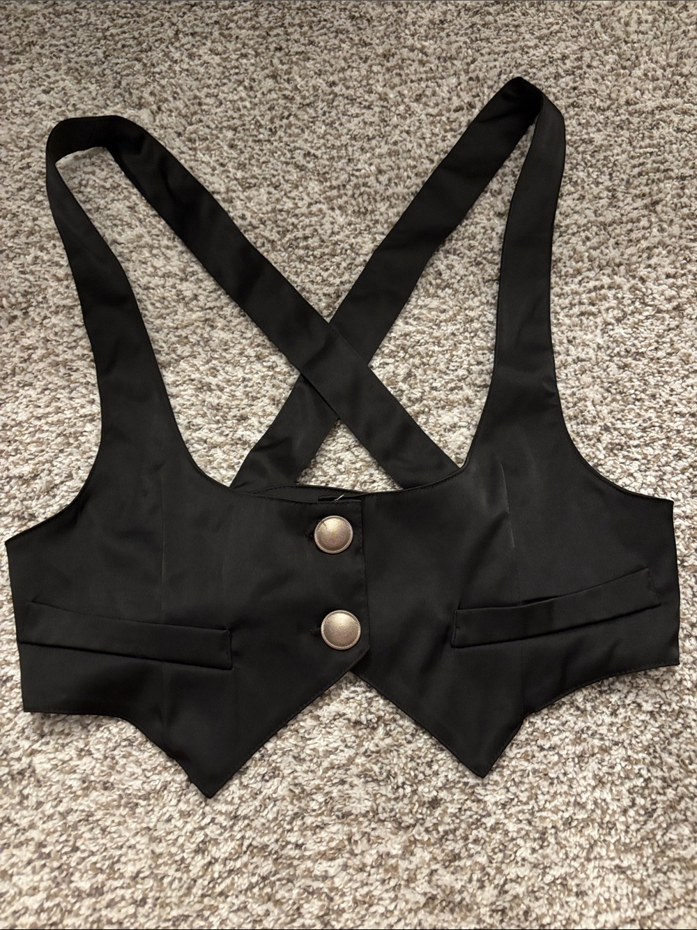 Black vest top with criss-cross straps and silver buttons